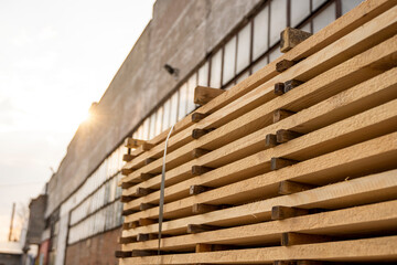 Storage of piles of wooden boards on the sawmill. Boards are stacked in a carpentry shop. Sawing drying and marketing of wood. Pine lumber for furniture production, construction. Lumber Industry.