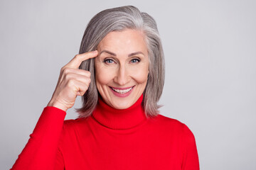 Photo of attractive aged woman happy positive smile finger touch head memory think isolated over grey color background