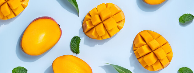 Mango design concept. Diced fresh mango fruit on blue table background.