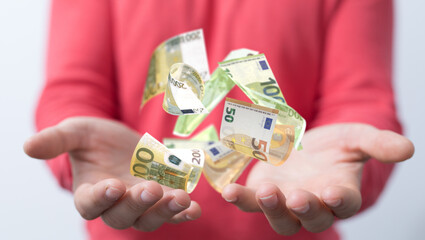 euro bills flying around  in hand