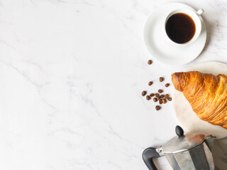 Flat lay frame of cups of coffee and croissant on marble background