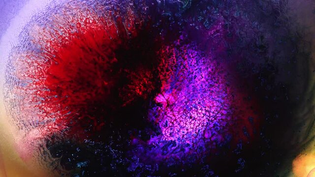 Neon red purple vivid colors ink and shiny particles macro. Liquid abstract painting texture. Moving colorful amazing organic background. Fluid art. The Universe, the Cosmos, Nebula, Space, Big Bang