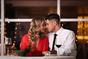 Lovely couple having romantic dinner on Valentine's day in restaurant