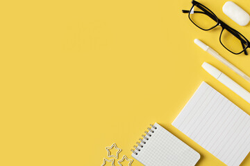 Back to school theme with papernote and white schools tools on yellow background