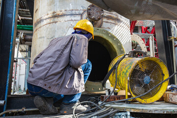 Male into the tank oil area confined space © chitsanupong