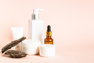 Natural cosmetic concept. Skincare product with tree bark at pastel background. Biophilic design.