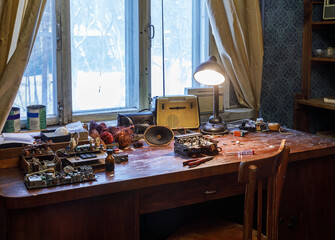 Wooden table littered with radio parts