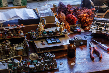 Radio parts and tools lying in disarray on the table