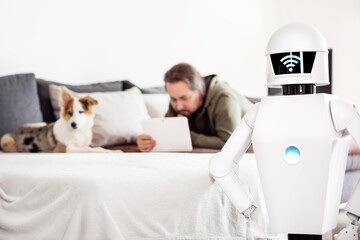 man with service robot in the living room
