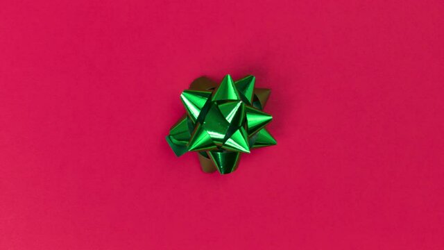 Unwrapping gift revealing a green screen - Stop Motion Animation - Green bow on a red background