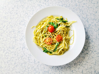 Pasta with pesto sauce and nuts on a the table