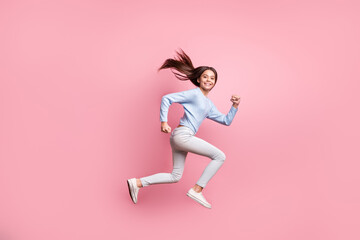 Fototapeta na wymiar Full length body size profile side view of lovely cheerful girl jumping running active movement isolated over pink pastel color background