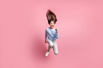 Full length body size view of nice trendy funky cheerful girl jumping running fast motion isolated over pink pastel color background