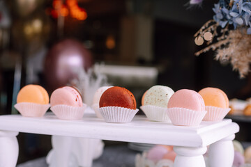 Delicious candy bar in pastel colors with colorful macaroons. Sweets for a wedding or birthday. Edible decoration
