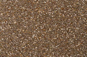 Chia seeds, background, from above. Fruits of Salvia hispanica. Oval and gray fruits with black and white spots, very hygroscopic, giving foods a distinctive gel structure. Backdrop. Macro food photo.