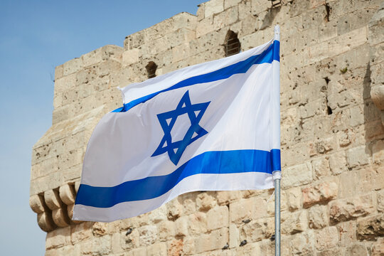 flag of Israel against the sky and the wall