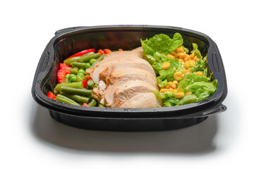 Ready food in a container. Stewed chicken, stewed vegetables.