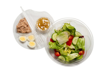 Fresh tuna salad with lettuce, cucombers, cherries and eggs in plastic container.