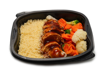 Ready food in a container. Stewed chicken in teriyaki sauce, stewed carrot, cabbage and porridge.