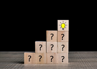 Creative idea and innovation concept. Wooden cube block light bulb icon on top with question icon.