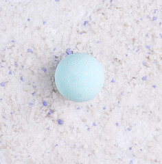 Blue bath bomb on salt texture. view from above