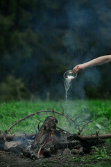 A man puts out a fire in the forest.