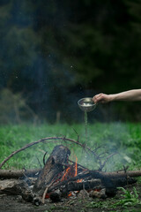 A man puts out a fire in the forest.