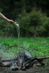 A man puts out a fire in the forest.