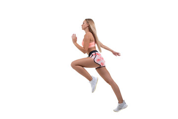 Fototapeta na wymiar A sporty young woman in a pink top, shorts and sneakers runs forward on a white background