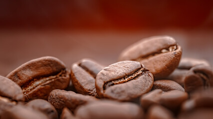 Close up of seeds of coffee. Fragrant coffee beans are roasted smoke comes from coffee beans.