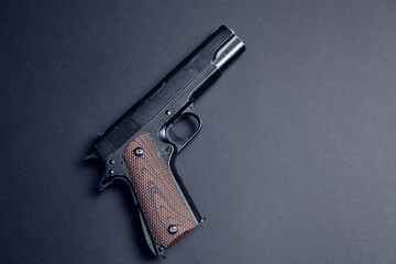 pistol on a black background - obrazy, fototapety, plakaty