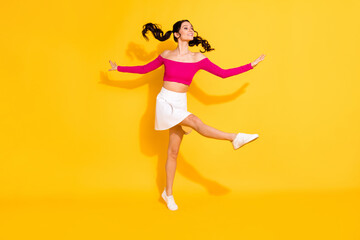 Fototapeta na wymiar Full body profile side photo of young cheerful girl happy positive smile have fun enjoy isolated over yellow color background