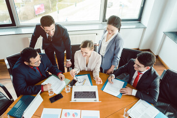 Five business people in a project meeting