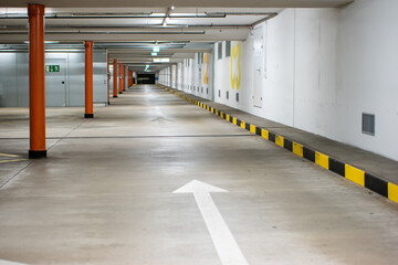 Empty illuminated underground car parking space large area wide angle view no people
