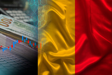 national flag of Belgium on satin, dollar bills, computer, concept of global trading on the stock exchange, falling and rising prices for world currency