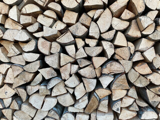 chopped dry alder wood in a woodpile. firewood for the stove and fireplace