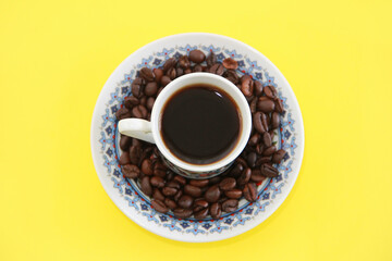 black turkish coffee in a mug and natural coffee beans