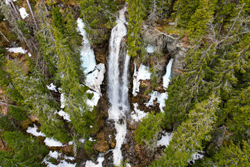 waterfall foss in norway with trees, water