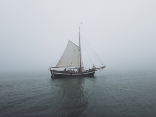 Fototapeta na wymiar Ship sailing in the sea on a foggy day
