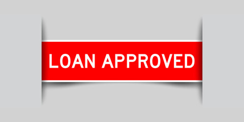 Inserted red color label sticker with word loan approved on gray background