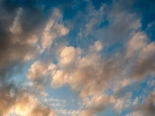 Obraz premium Spectacular Clouds in Evening Light of Sunset on Blue Sky Background - Overcast Western Sky in Spring Dusk Time - Belarus Minsk