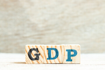 Alphabet letter block in word GDP (Abbreviation of good distribution practice or gross domestic product) on wood background