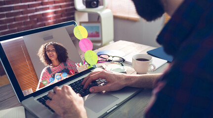 Caucasian businessman sitting at desk using laptop having video call with female colleague