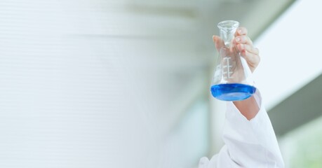 Composition of female scientist in lab holding flask with fluid with motion blur