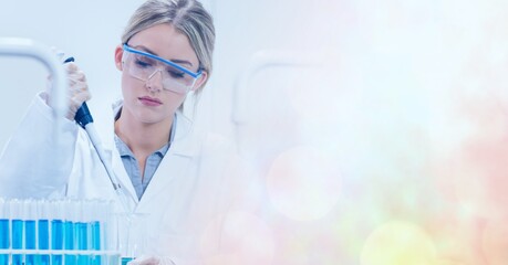 Composition of female scientist in lab using pipette and test tubes with motion blur