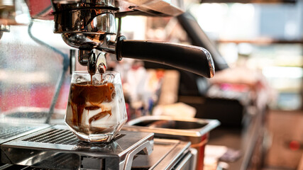 Close-up of iced coffee served on black table at cafe​