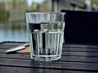 Glass of water on a wooden table
