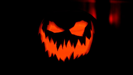 Fototapeta premium Halloween pumpkin smile and scary eyes at black background