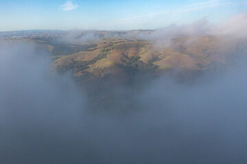 The marine layer sweeps over the serene hills of the East Bay, just east of San Francisco Bay, California. This area has a number of parks and open spaces available to explore by hiking and biking.
