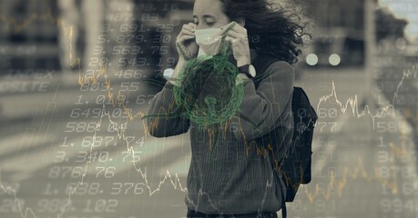 Composition of data processing and covid 19 cell over woman wearing face mask in city